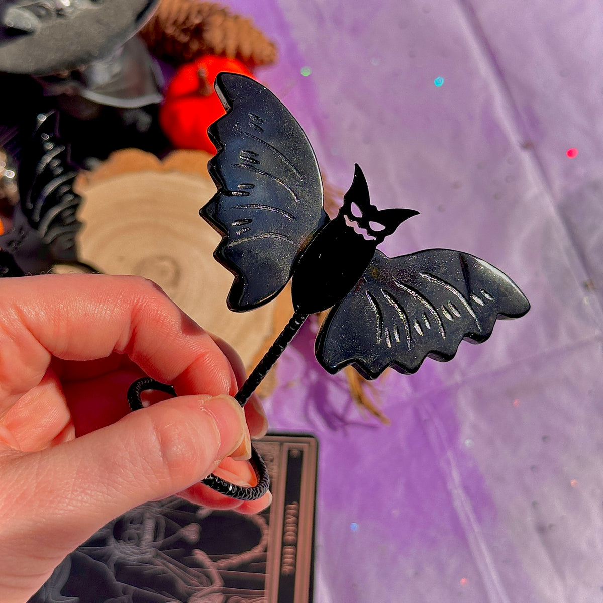 obsidian bat carving on stand