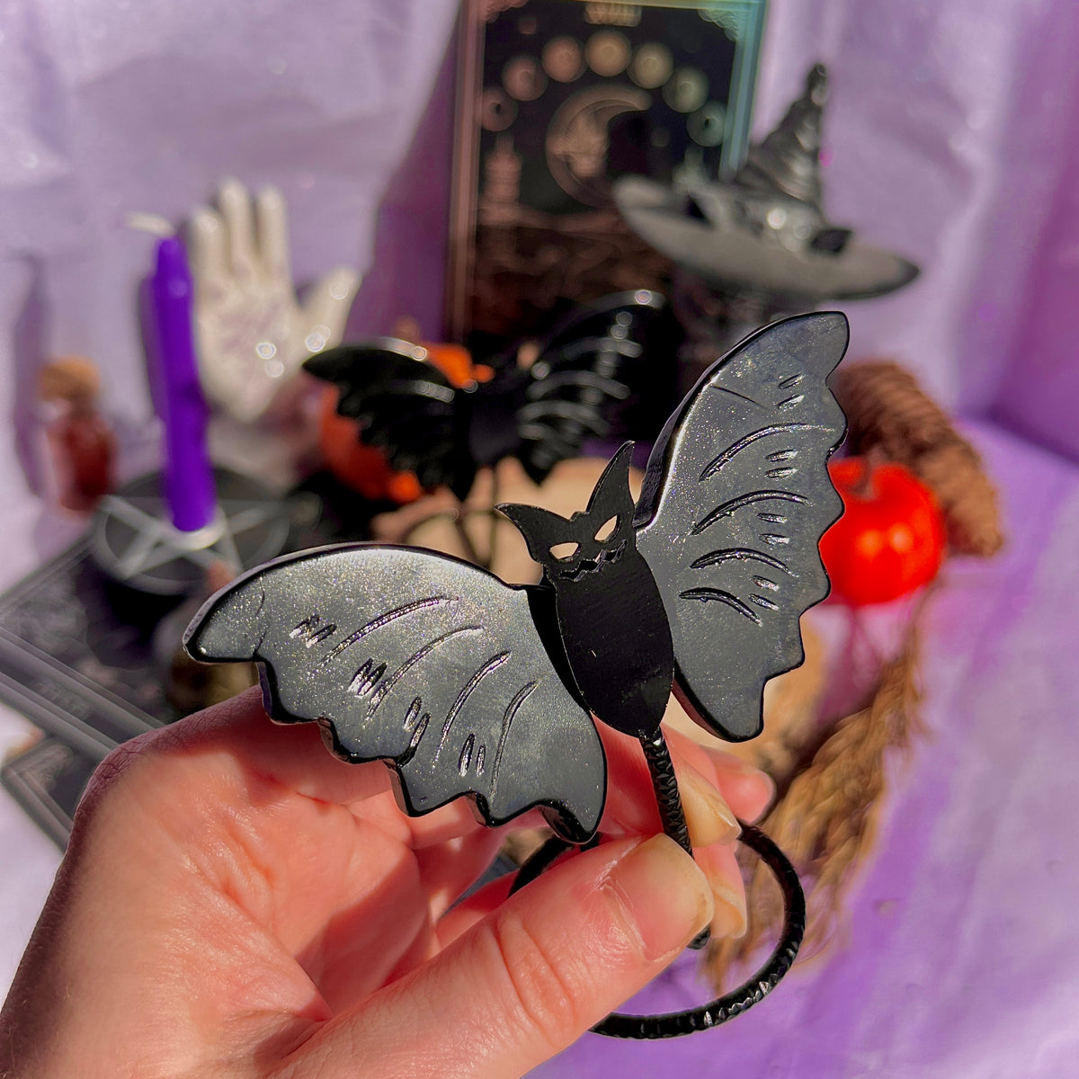 obsidian bat carving on stand