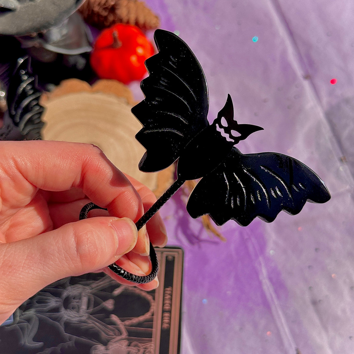 obsidian bat carving on stand
