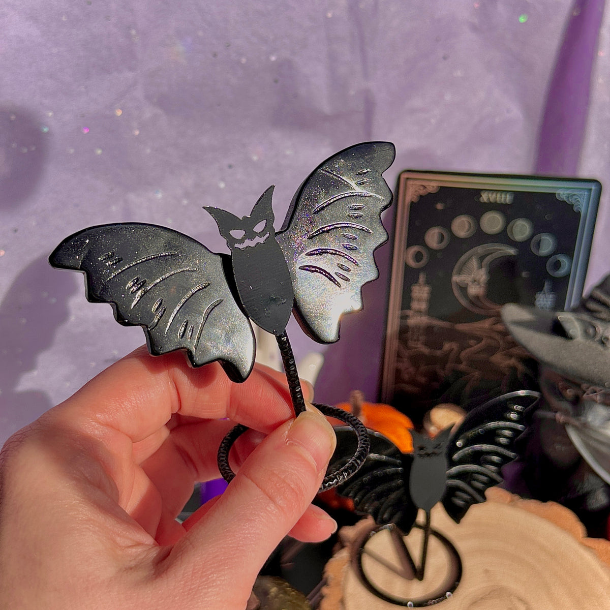 obsidian bat carving on stand
