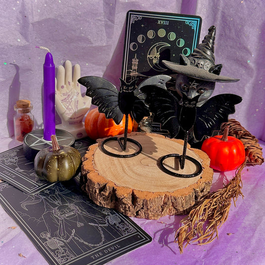 obsidian bat carving on stand