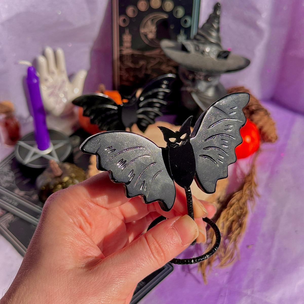obsidian bat carving on stand
