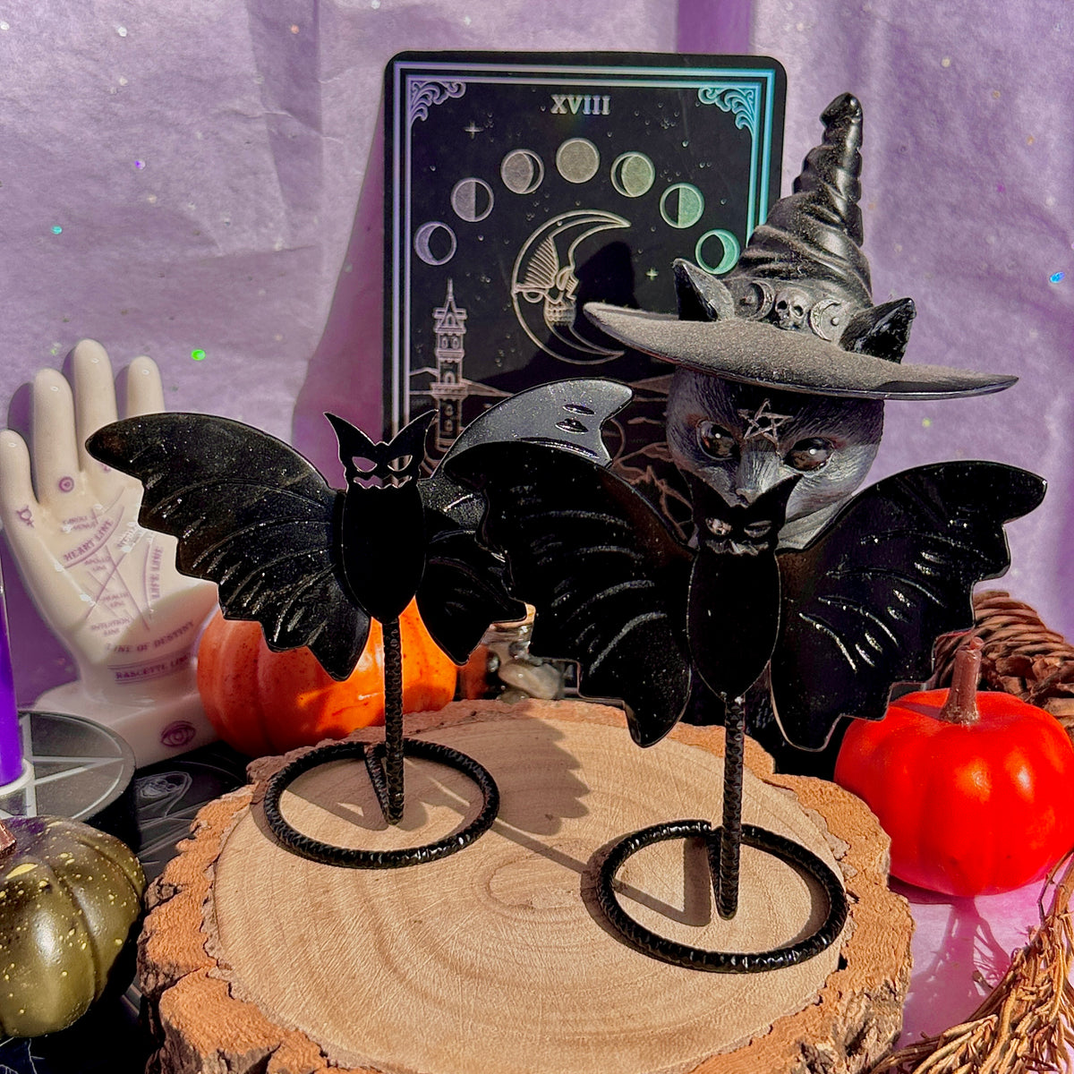 obsidian bat carving on stand