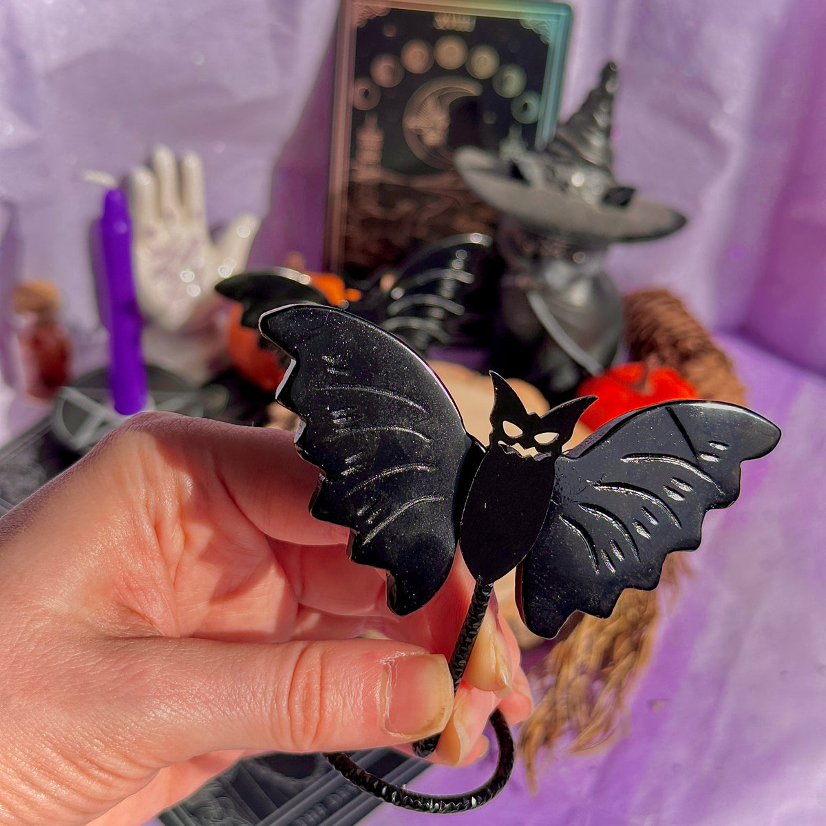 obsidian bat carving on stand
