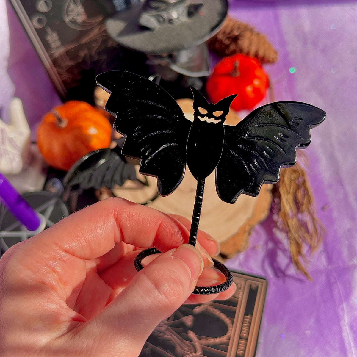 obsidian bat carving on stand