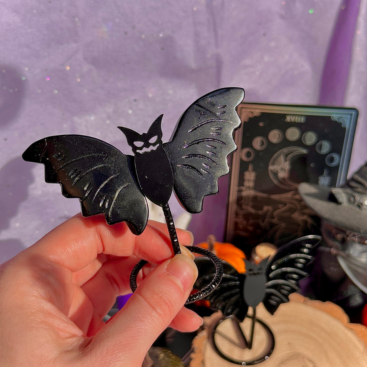 obsidian bat carving on stand