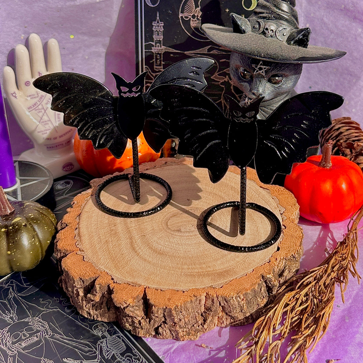 obsidian bat carving on stand